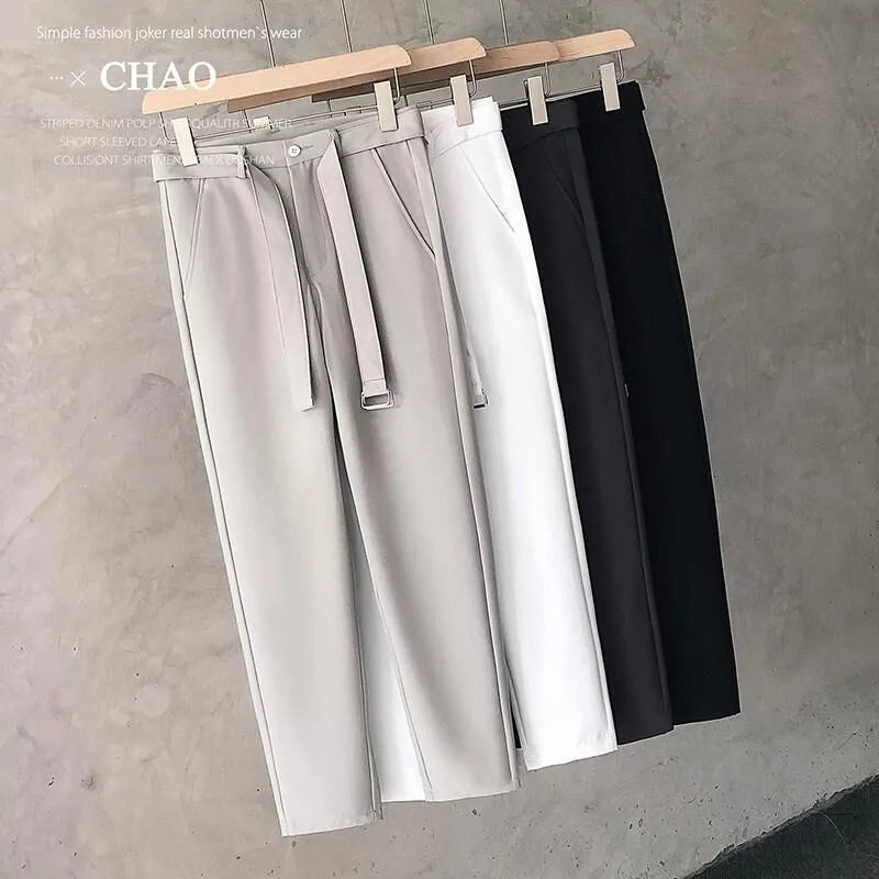 Boy wearing slim straight grey wool blend trousers in a business casual style.