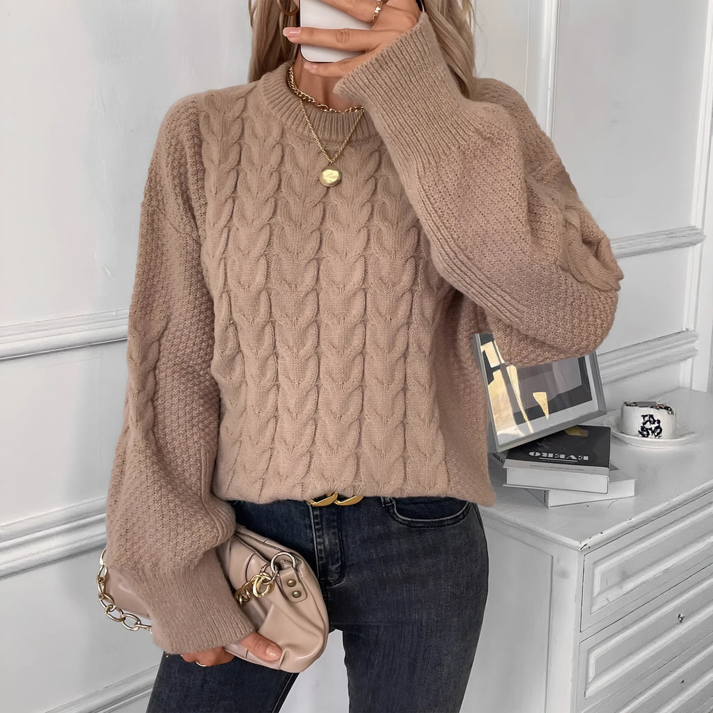 Beige women's loose casual sweater with a textured twist detail on the front.