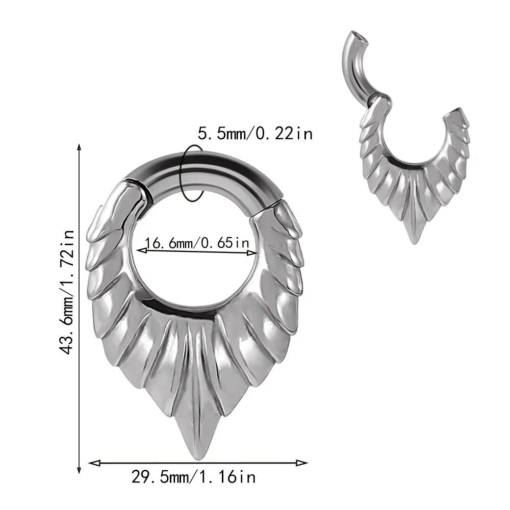 Close-up of a stainless steel drop-shaped ear extender with totem patterns, hanging vertically.