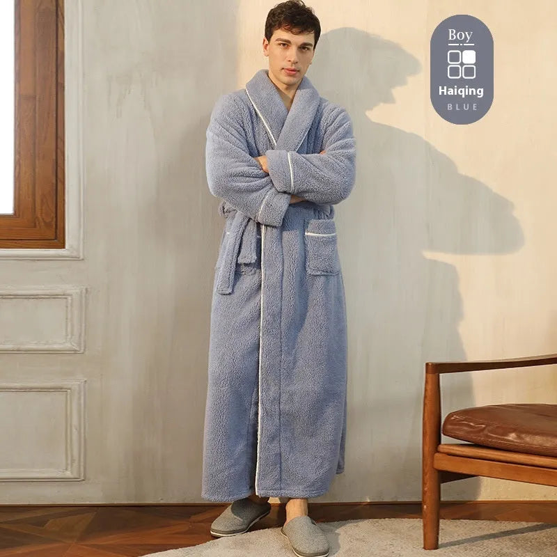 A man and woman wearing matching navy blue thick flannel bathrobes, showcasing the wrap-around design and plush fabric.