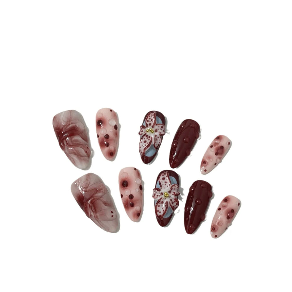 Hand-painted 3D carved manicure nail set showing rose, tulip and butterfly patterns in medium almond length