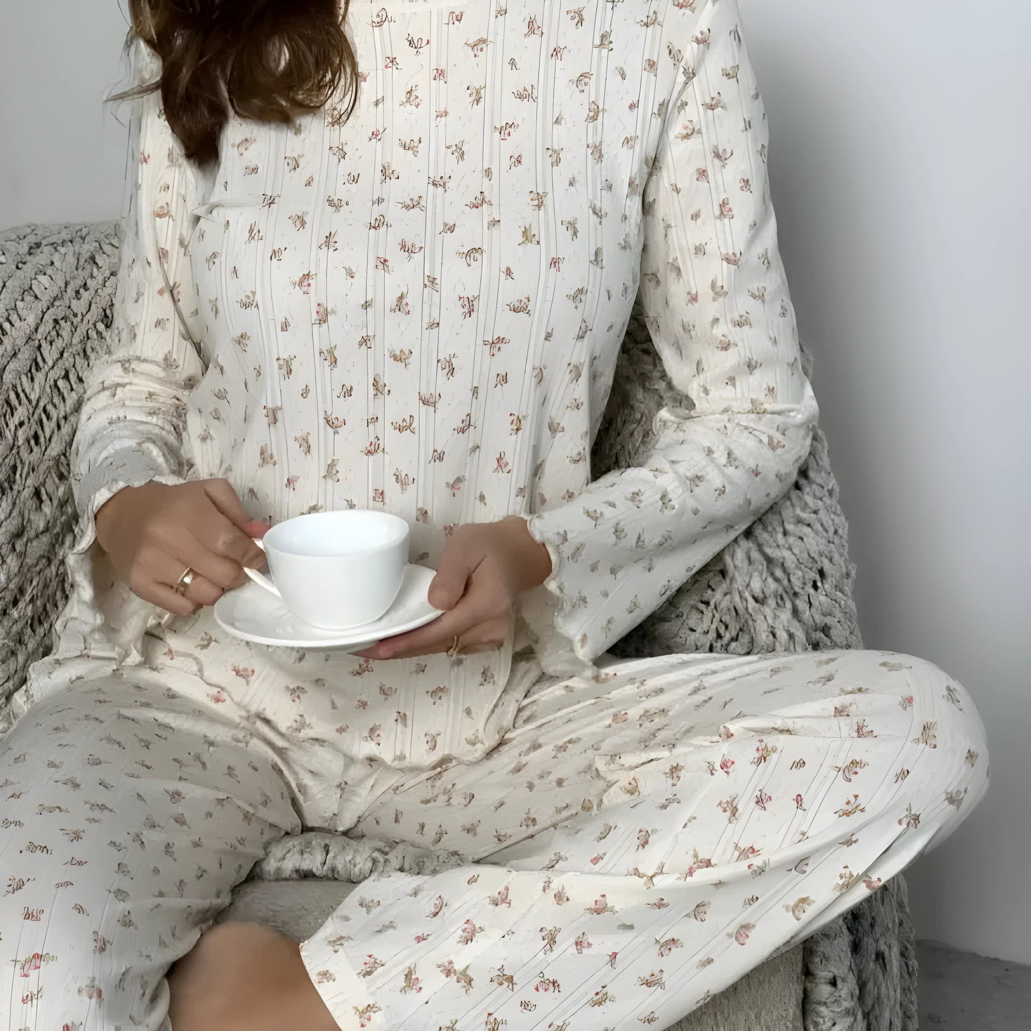 Women's white floral print bell sleeve top and wide-leg trousers loungewear set on a hanger.