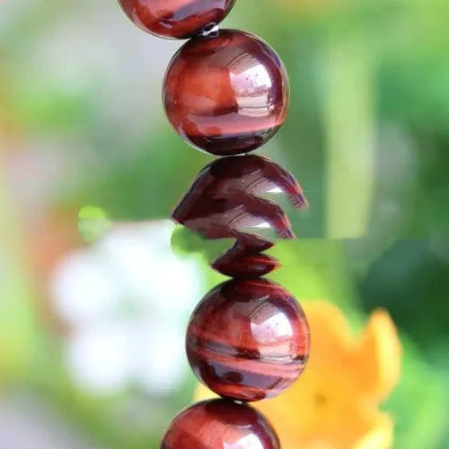 Red tigereye cat's eye beaded bracelet, grade 7A Lightning Eye Reserva, round geometric wood alexandrite beads