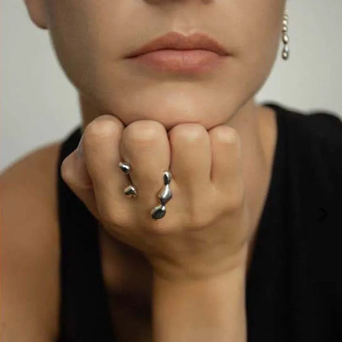 Brass opening ring in gold or silver finish with spherical design details.