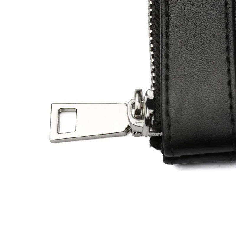 Black plaid textured men's leather clutch wallet showing front view.