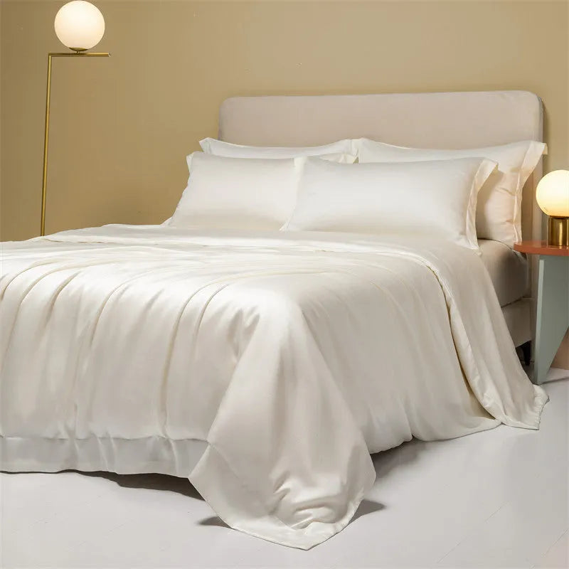 A modern, neatly made bed with a Lenzing Tencel duvet cover and pillowcases in a choice of nine colours like Sea Salt Blue.
