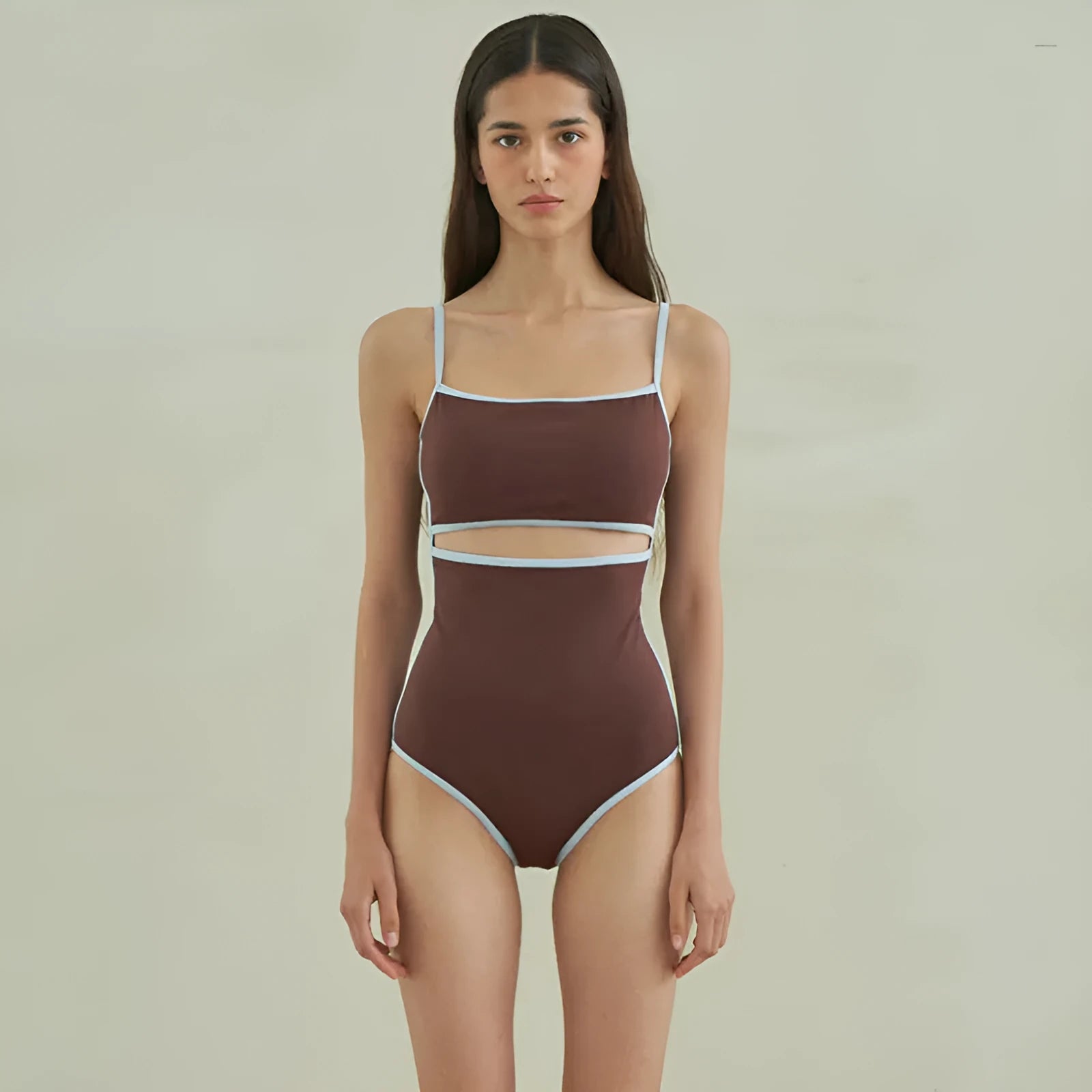 Brown one-piece swimsuit for women on a mannequin, showing the front design.