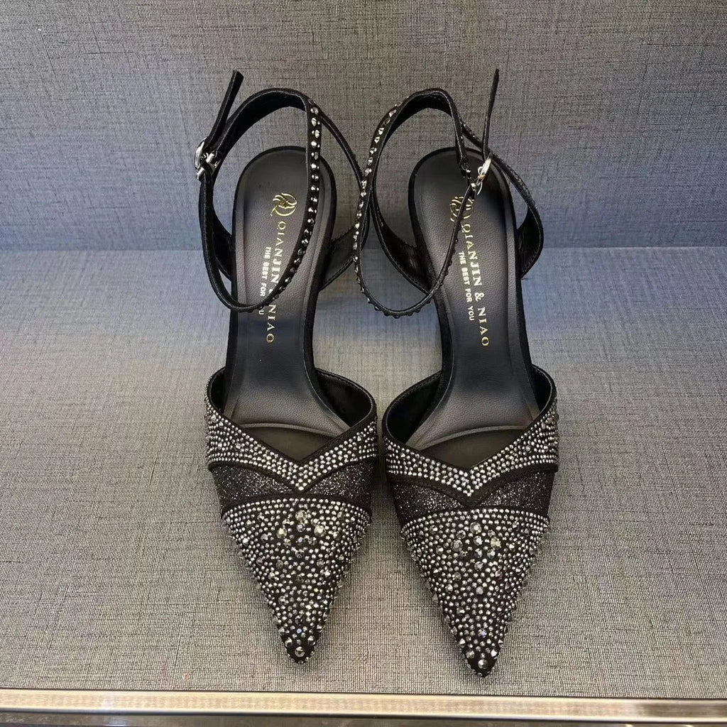 Women's black and silver hollow-cut stiletto heels with a pointed toe and shallow mouth design.