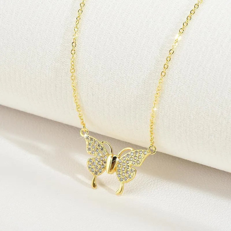 Women's clavicle necklace with butterfly pendant on twisted chain, showing magnetic snap closure