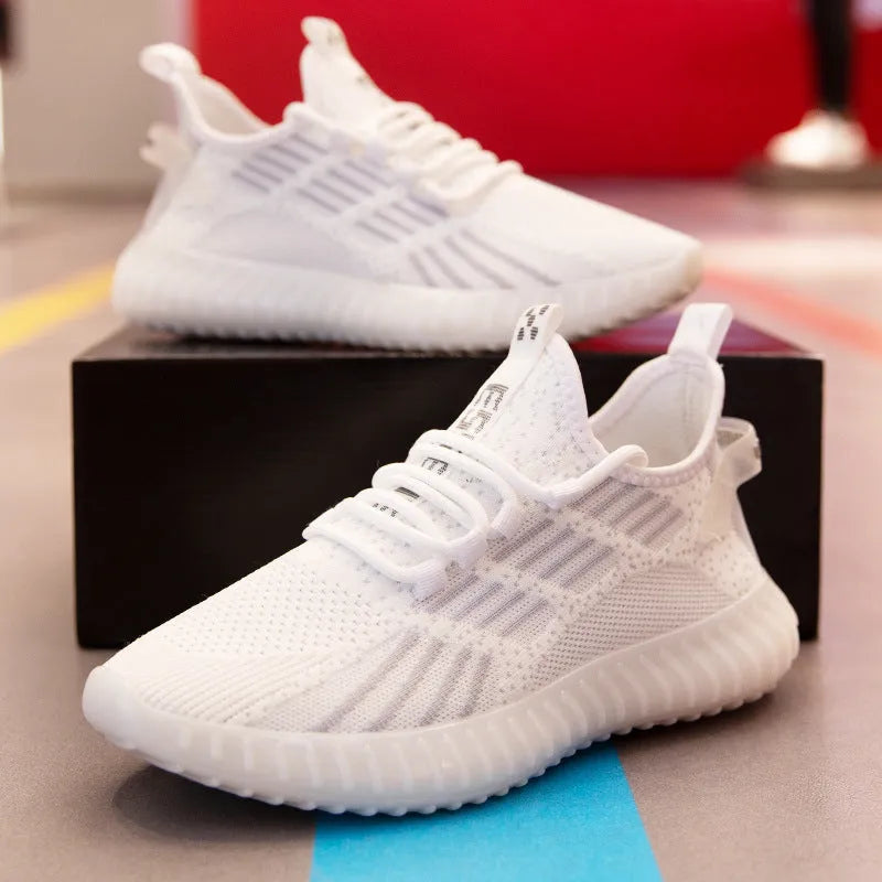 Men's white breathable flying fabric sports shoes with round toe and low-upper design.