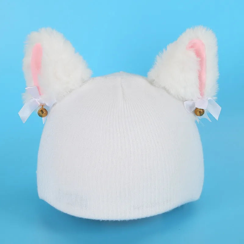 Colourful plush cartoon hat decoration sitting on top of a ski helmet