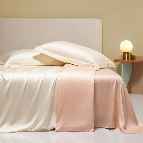 A modern, neatly made bed with a Lenzing Tencel duvet cover and pillowcases in a choice of nine colours like Sea Salt Blue.