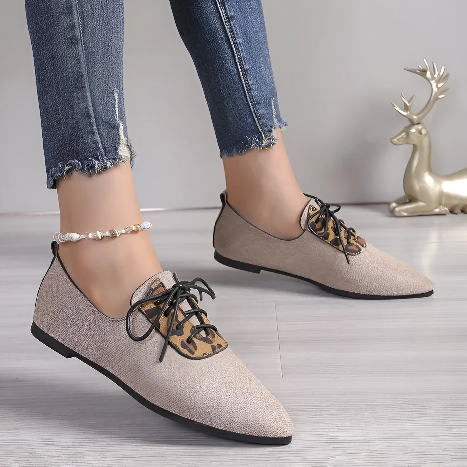 Beige leopard print women's pointed toe pumps with a rubber sole, shown in an extended size range.