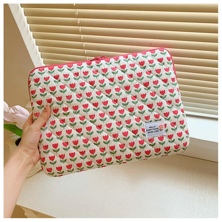 Green floral print cloth laptop bag with anti-seismic protection for 13 to 15 inch computers.