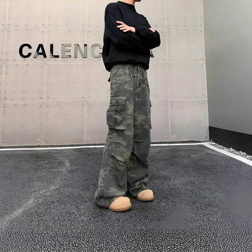 American Vintage camouflage cargo pants with multiple pockets and a crumpled, washed fabric texture laid flat.