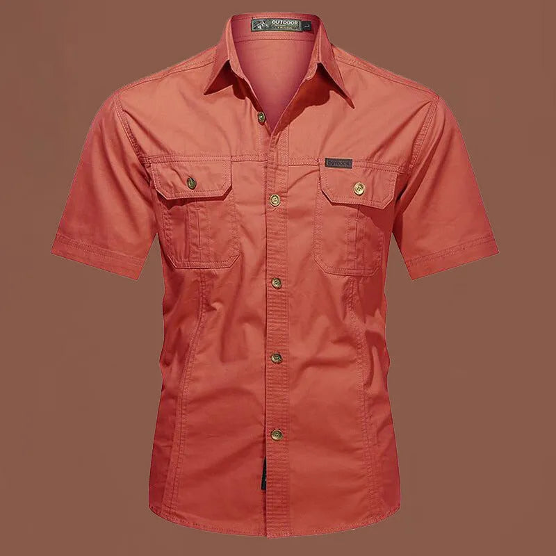 Man wearing a loose-fitting short sleeve cotton work shirt in a cardigan style.