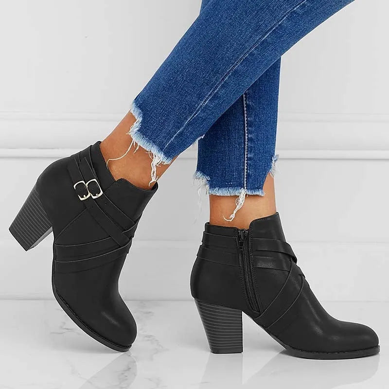 Plus size black short boot with side zipper, buckle, and a 7cm thick rubber heel.