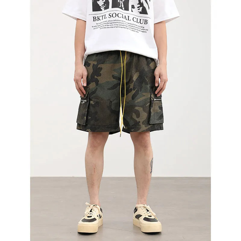 Men's camouflage pattern work shorts with multiple pockets, cropped length, and mid waist design