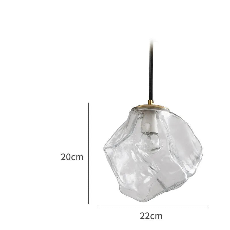 Minimalist ice cube glass chandelier with warm 4000K light, smoky grey shade and black hanging wire over a dining table