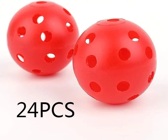 Multi-colour golf practice balls with 26-hole design on a green surface next to a net pocket.
