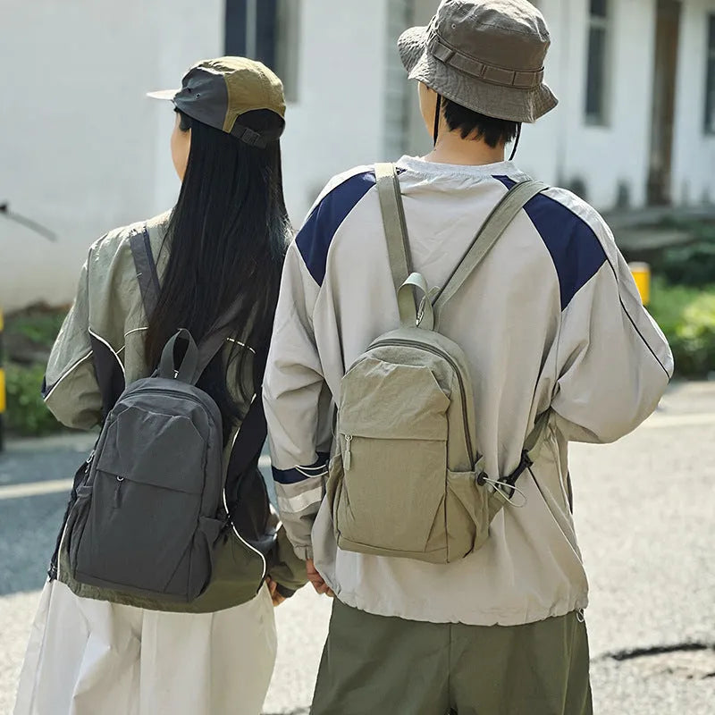 Multi-functional waterproof nylon backpack in black, free size, with curved shoulder strap and visible sewing thread detailing