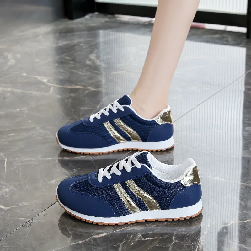 Blue women's lightweight sports shoes with cross straps and lace-up front on a flat rubber sole.