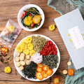 Honeysuckle chrysanthemum tea bags packaging showing 150g net content with optional gift tea cups