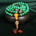 Natural turquoise bracelet with 108 round 8mm beads on a white background.