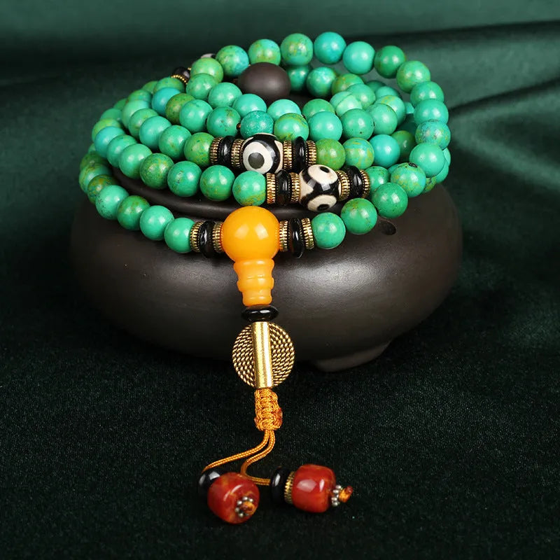 Natural turquoise bracelet with 108 round 8mm beads on a white background.