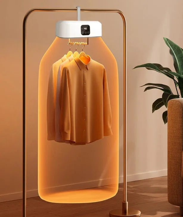 White cylindrical portable clothes dryer with remote control, folded for compact storage