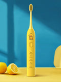 Yellow duck design rechargeable electric toothbrush with soft bristles on a white background.