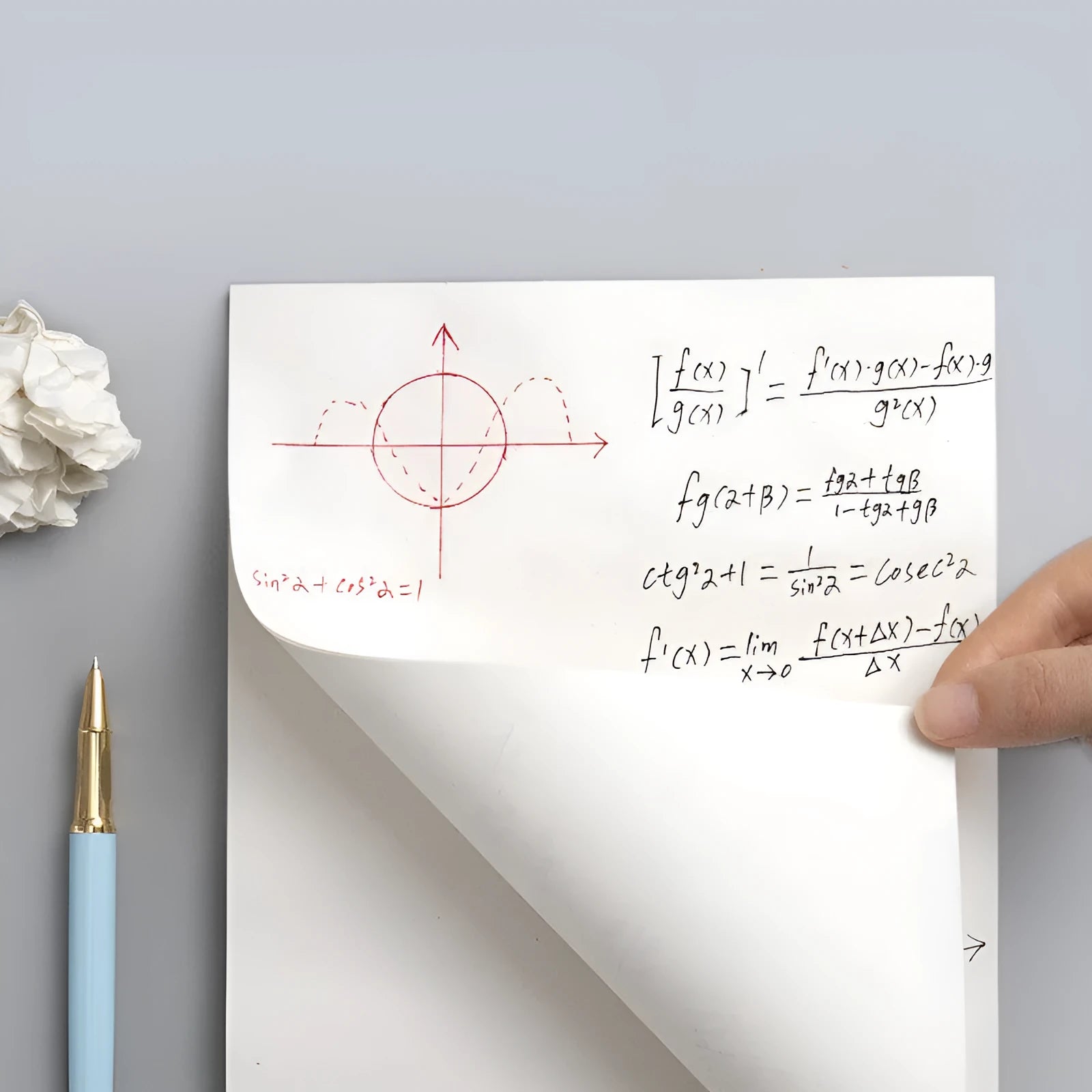 A4 blank draft notebook with picture colour cover, open to show unlined pages, placed on a desk with a pen.