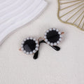Round pearl-rimmed sunglasses for a cat or dog, shown in multiple colours including black, blue, and orange.