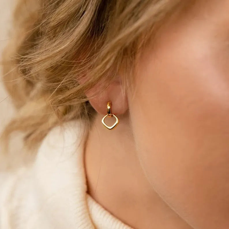 Copper geometric square double ring twist ear clip earrings on display