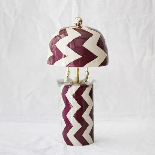 Striped table lamp with matte finish, pushbutton switch, and UK plug on a desk
