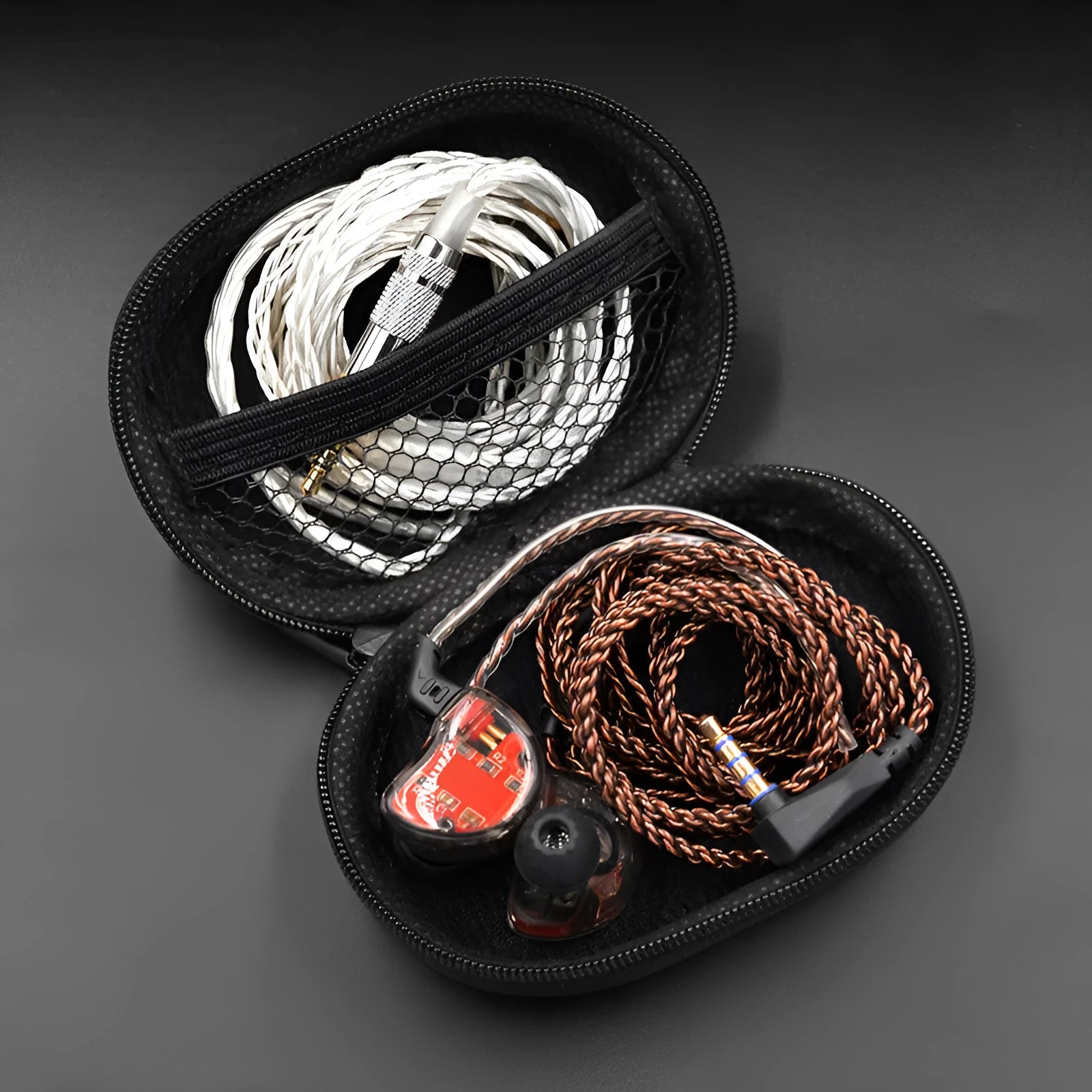 Black oval leather earphone storage bag with a zip closure, open to show soft-lined interior.