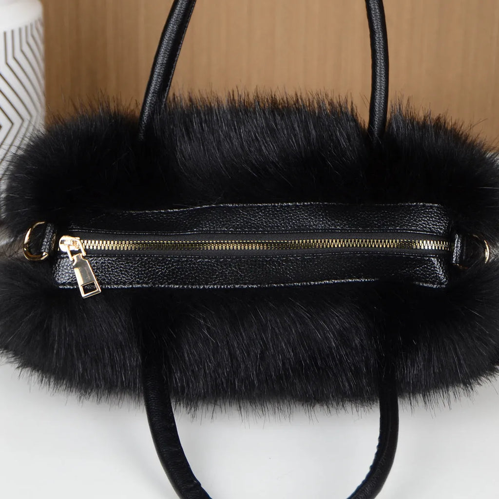Hand-carrying square plush bag in pink with soft faux fur exterior and horizontal shape