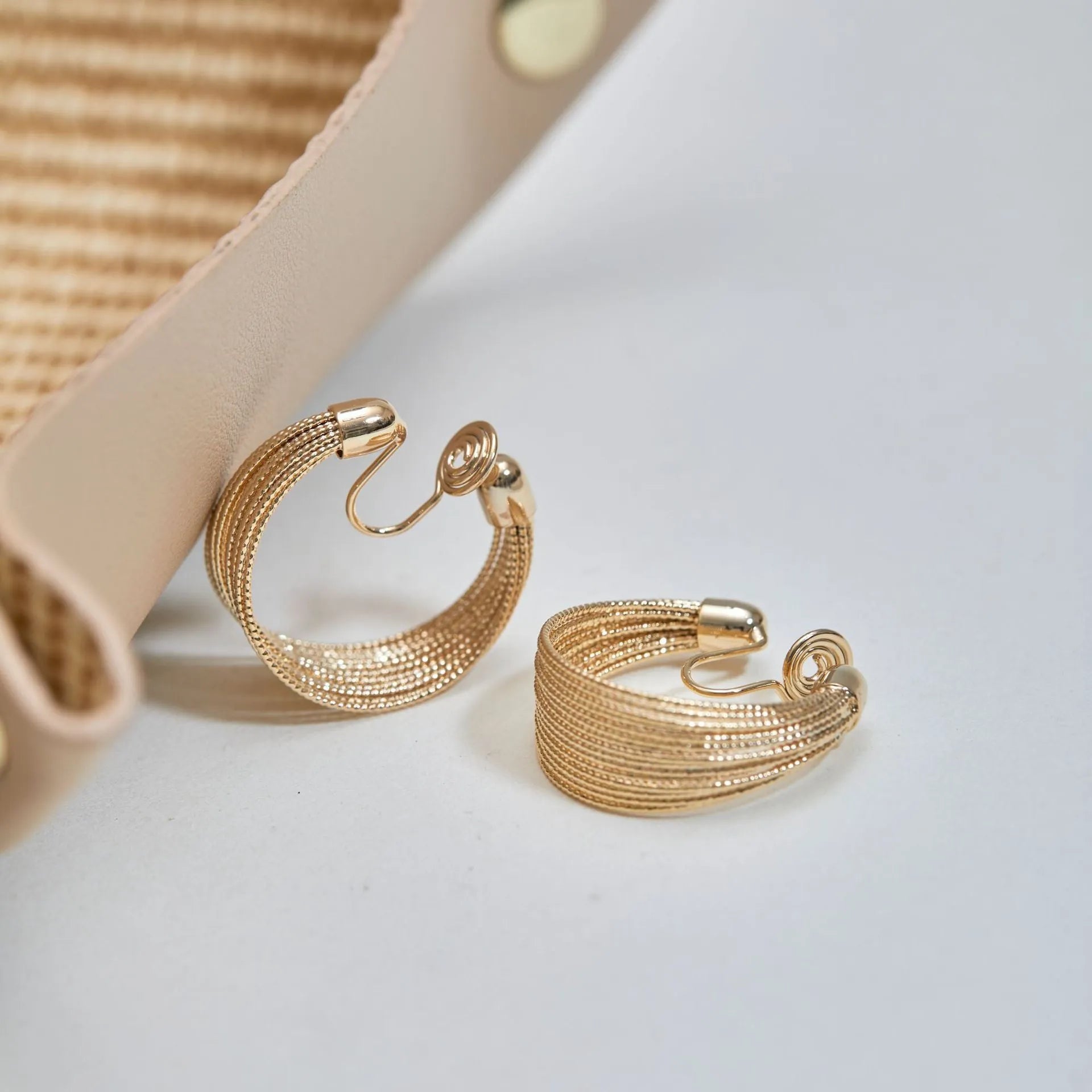 Simple geometric bracelet earrings with clip and stud backs in silver or gold colour.