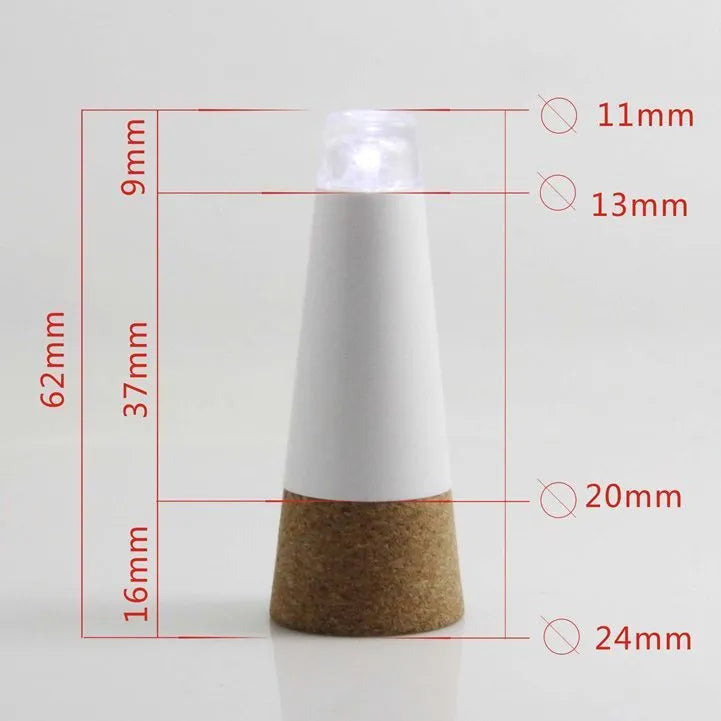 White plastic USB-rechargeable LED bottle cap cork light with micro-USB port, shown next to a whisky bottle.