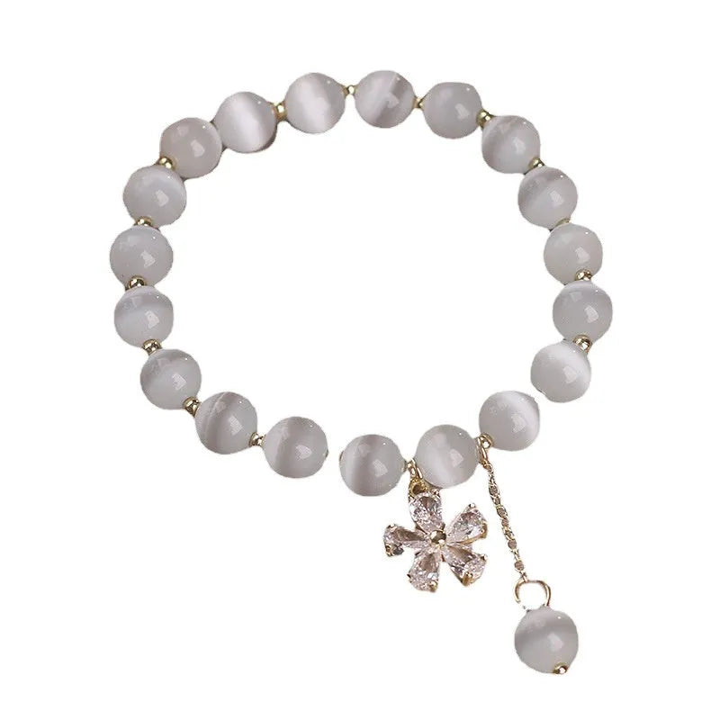White cat's eye crystal bracelet with floral tassel and morganite safety buckle