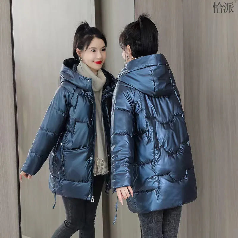 A woman wearing a green ultra-thin hooded winter jacket with long sleeves, showing the front design.