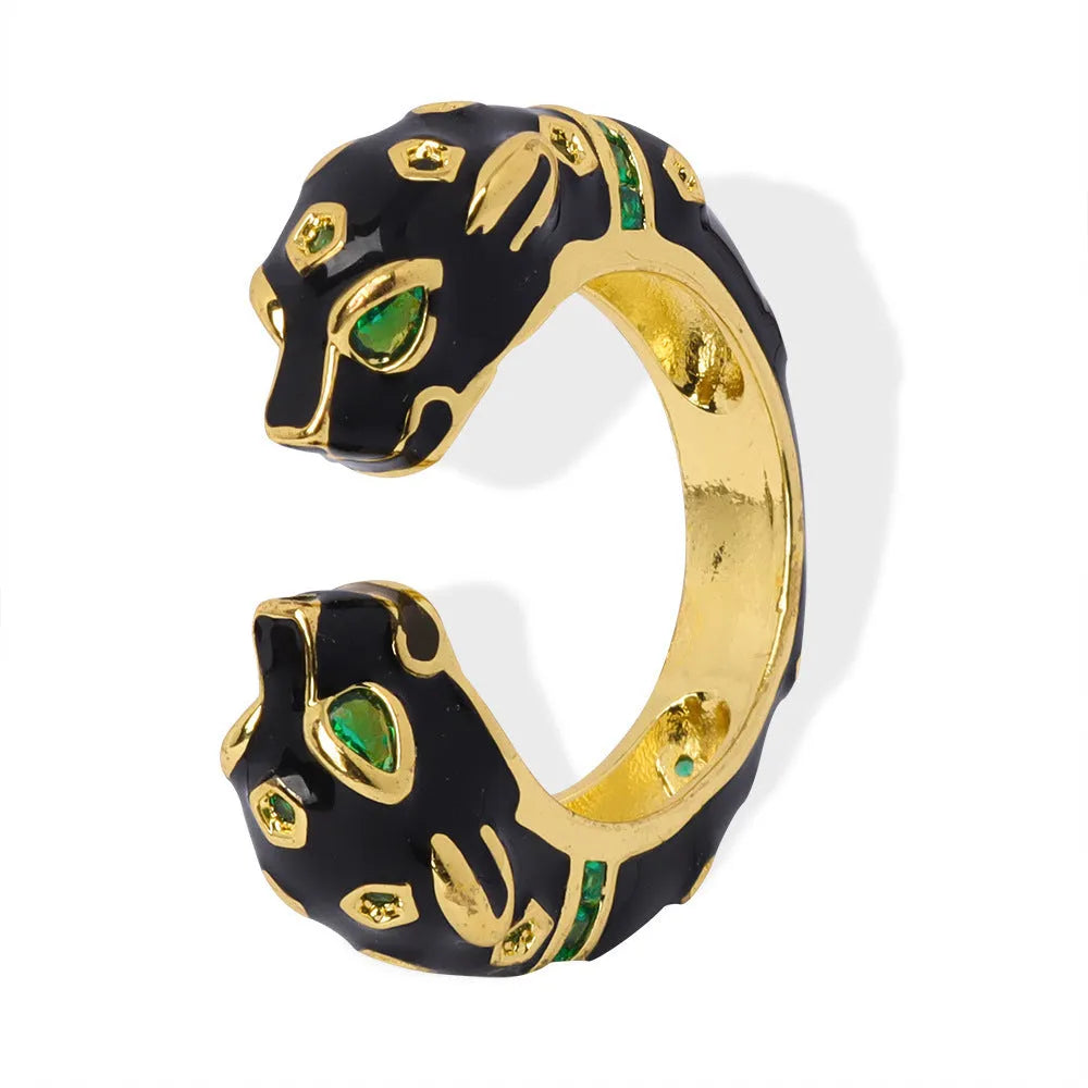 Geometric open fashion ring with a black cheetah print pattern, shown on a model's hand.