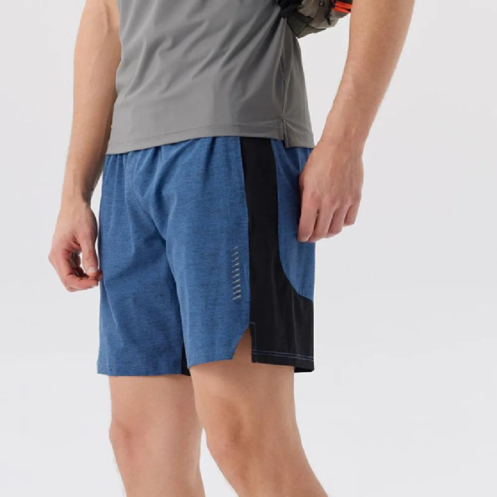 Man wearing forest green stretch spandex shorts, showing mid-waist fit and casual short length.