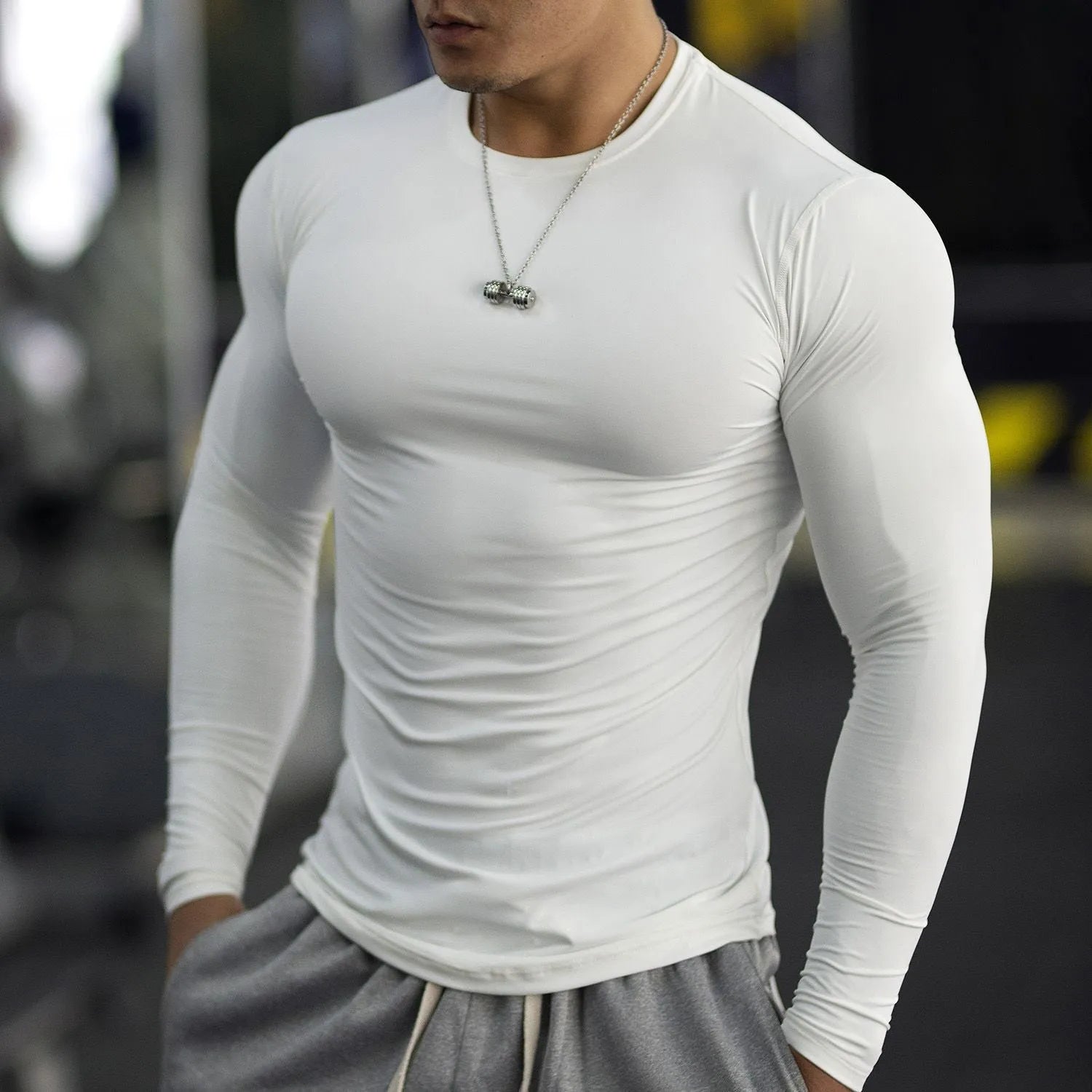 Men's black fitness tights with long sleeves and slim fit design for athletic activities