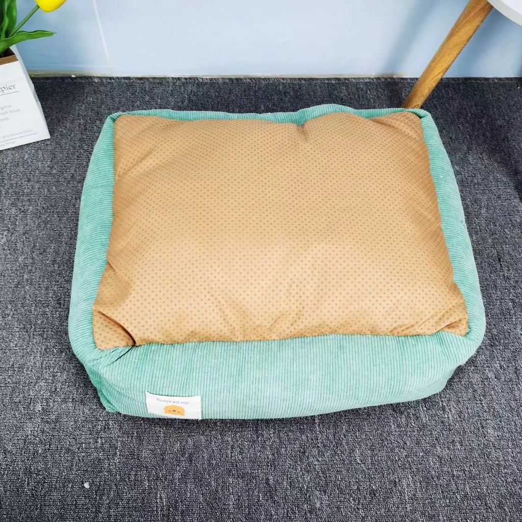 Light blue pet nest for dogs and cats on a wooden floor, showing its plush fabric and padded sides.