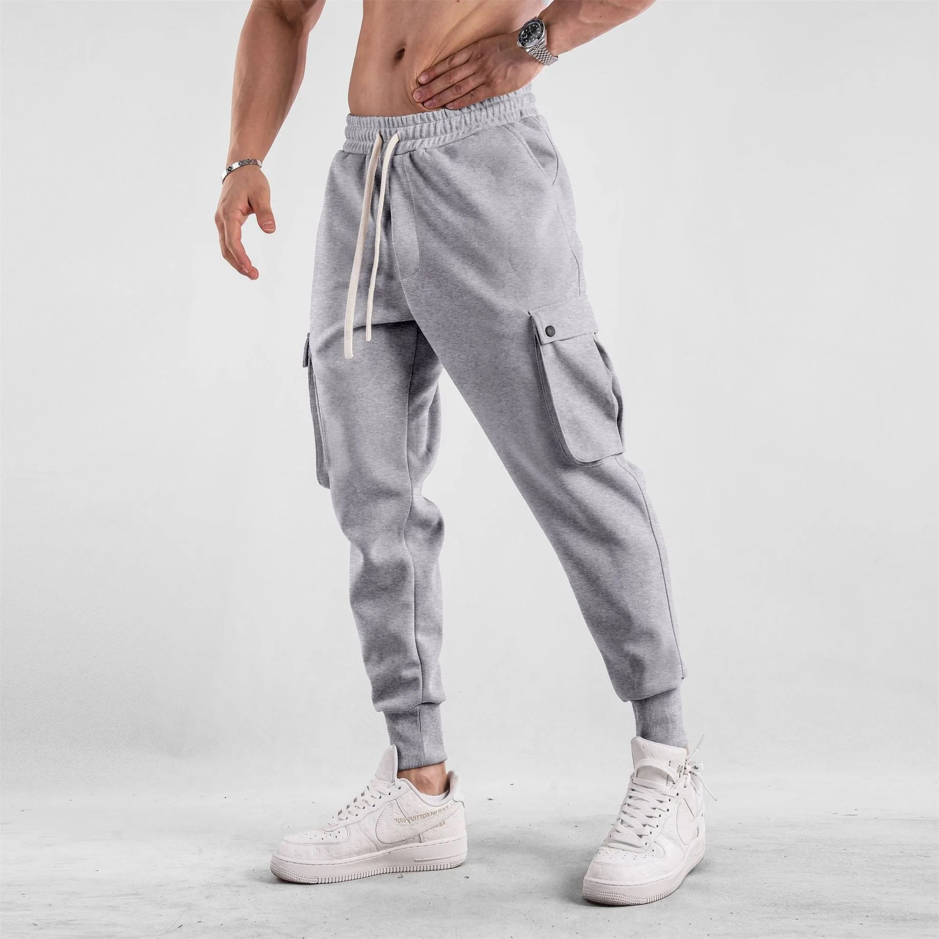 Men's loose-fit cotton sports trousers with ankle ties and multiple pockets in solid colour