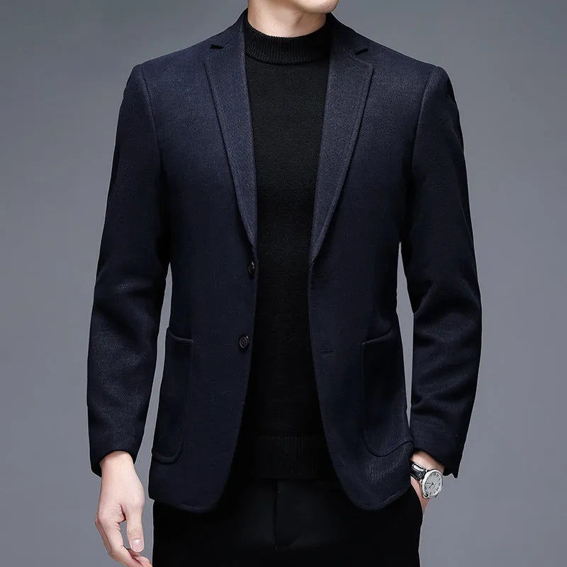 A man wearing a solid-colour loose-fit casual wool-style jacket with a round hem and long sleeves.