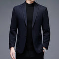 A man wearing a solid-colour loose-fit casual wool-style jacket with a round hem and long sleeves.