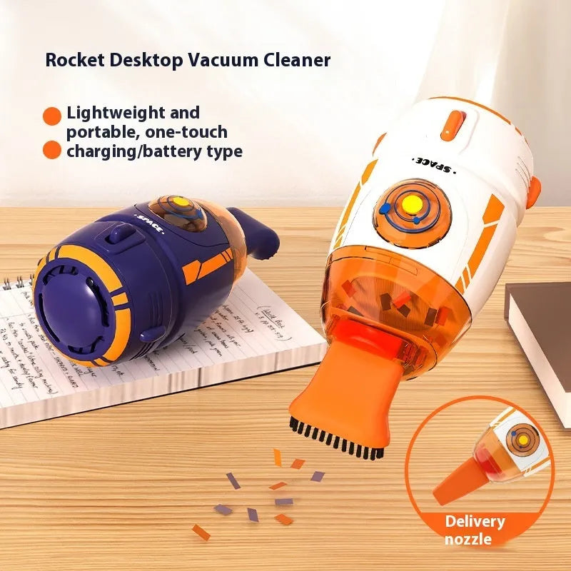 USB-powered handheld desktop vacuum cleaner in blue rocket design on a wooden desk next to a keyboard.