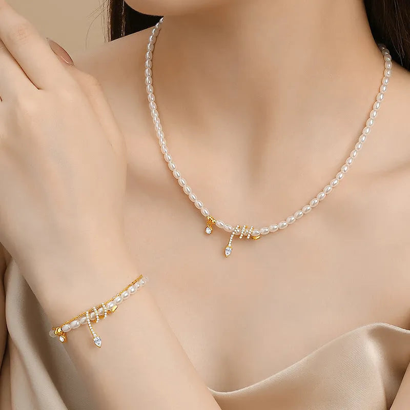 Close-up of a women's silver bracelet with a detailed pearl snake design, shown in both gold and white gold colour options.
